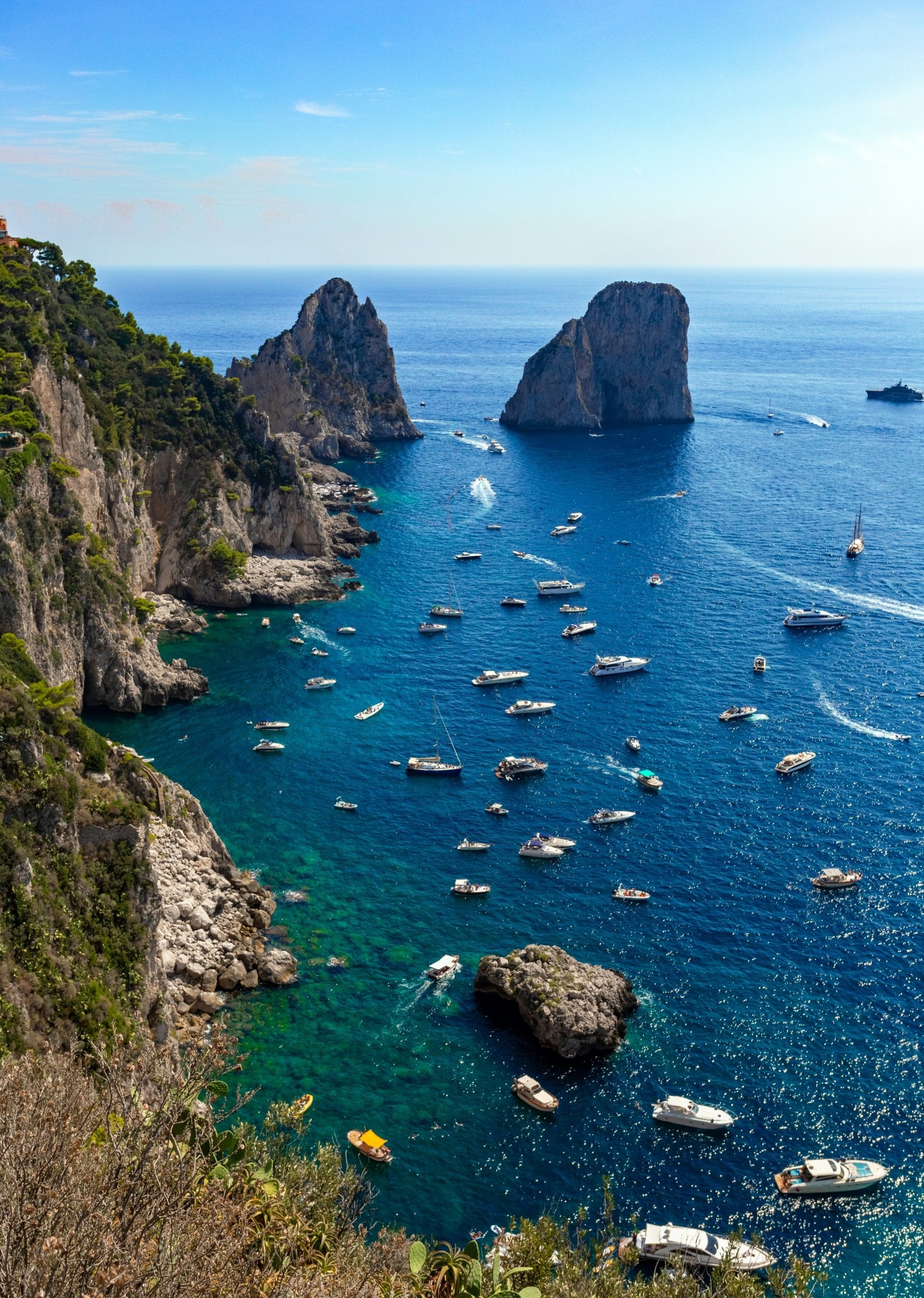 The Faraglioni rocks off Capri with boats anchored in deep blue water